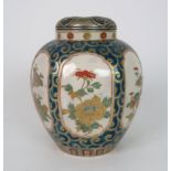 A SATSUMA HEXAGONAL JAR AND COVER painted with moulded panels of flowers on a green and gilt