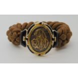 A FRENCH 18CT GOLD HAIR MOURNING BRACELET the black and white enamelled clasp is stamped with the
