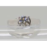 AN 18CT WHITE GOLD DIAMOND SOLITAIRE RING with cross over bezel, and classic four claw setting