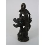 AN ASIAN BRONZE MODEL OF A DRAGON cast with a sinous head within a flaming arch set with a ring