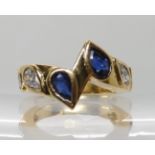 AN UNUSUAL BESPOKE SAPPHIRE AND DIAMOND RING set with four pear shaped sapphires and two pear cut