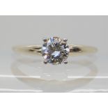 A 14K WHITE GOLD DIAMOND SOLITAIRE set with a 0.60ct brilliant cut diamond in classic four prong