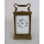 A CURTIS AND HORSPOOL BRASS AND GLASS REPEATING CARRIAGE CLOCK the white dial with Roman numerals,