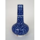 A CHINESE BLUE AND WHITE BALUSTER VASE painted all over with lilies and scrolling foliage, divided