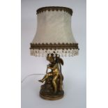 A GILT BRONZE CHERUB TABLE LAMP modelled seated holding a bow 38cm high Condition Report: