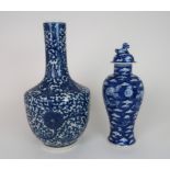 A CHINESE BLUE AND WHITE BALUSTER VASE painted with lilies and scrolling foliage, four character