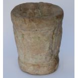 AN ANCIENT STONE MORTAR carved with a cross and with foliate banding, 30cm high and 24cm diameter