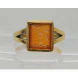 A 15CT GOLD INTAGLIO RING set with a hand carved carnelian intaglio depicting a family crest of a