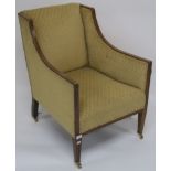 An Edwardian inlaid mahogany upholstered armchair on square tapering legs and brass castors, 80cm