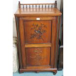 A Victorian mahogany music cabinet with a painted panel of a bird and lower carved panel with fitted