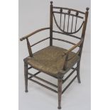 An Arts and Crafts chair with turned finials and rush seat, 82cm high Condition Report: