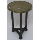 A circular brass topped oriental side table, 68cm high x 45cm diameter Condition Report: Available