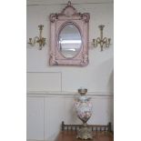 A pink Continental ceramic wall mirror with cherubs etc with replacement glass (def), a pair of