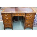 A mahogany twin pedestal desk with rexine skiver on bracket feet, 77cm high x 122cm wide x 61cm deep