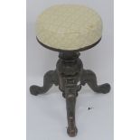 A Victorian walnut adjustable piano stool on carved support on tripod base Condition Report: