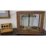 A set of scales in oak case with a boxed set of weights Condition Report: Available upon request