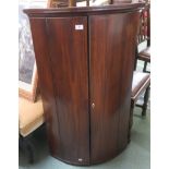 A Georgian mahogany bow front corner cabinet, 112cm high x 70cm wide x 46cm deep and a Georgian