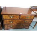 A Victorian mahogany and walnut two over two chest of drawers with brass handles on bracket feet,