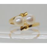 An 18k gold twin pearl ring size N1/2, weight 3gms Condition Report: Available upon request