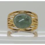 A 9ct gold wide band ring set with a green hardstone, size O1/2, weight 4.7gms Condition Report: