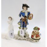 A continental figure of a man, a Villeroy and Boch snowman ornaments and a Doulton figure