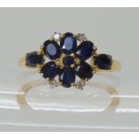 A 9ct gold sapphire and diamond accent flower ring, size N1/2, weight 2.2gms Condition Report: