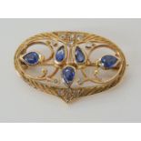 A bright yellow metal hand made sapphire and rose cut diamond brooch, dimensions 2.9cm x 1.9cm,