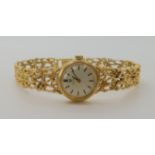 A 9ct gold ladies Omega watch with integral retro strap, length 19cm, diameter of the dial approx