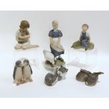 A collection of Royal Copenhagen figures including rabbits, kitten, goose girl, children etc