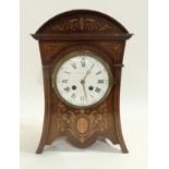 An Edward and Sons Edwardian mantle clock, the inlaid case with white enamel dial with Roman