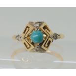 An 18k gold ring with key pattern design set with turquoise and clear gems, size J1/2, weight 2.5gms