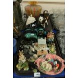 A lot comprising Poole pottery models of a dolphin and dog, a mottled multi coloured glass vase,