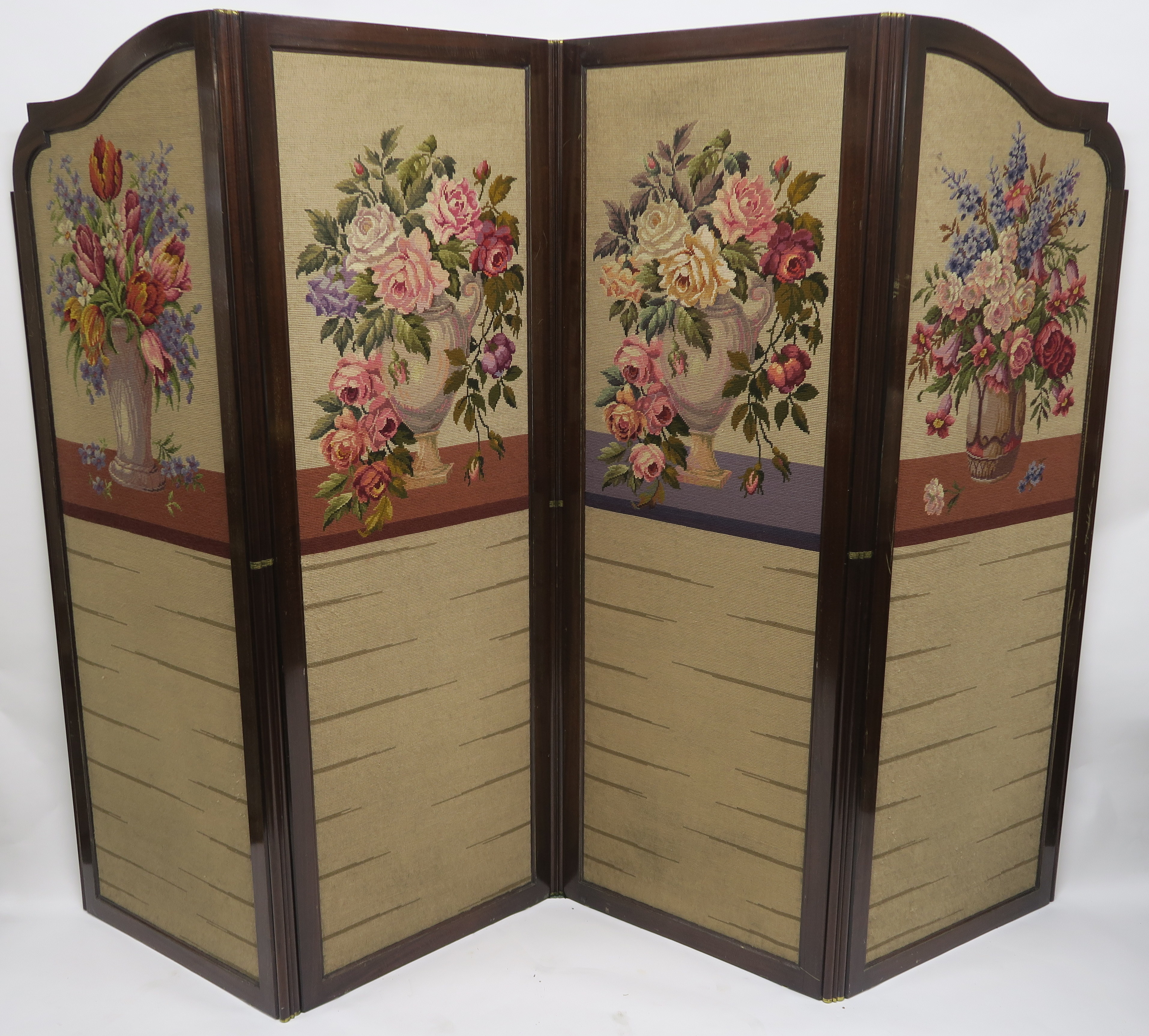 A 20TH CENTURY MAHOGANY FOUR FOLD SCREEN, with wool work panels of flowers in vases, each panel