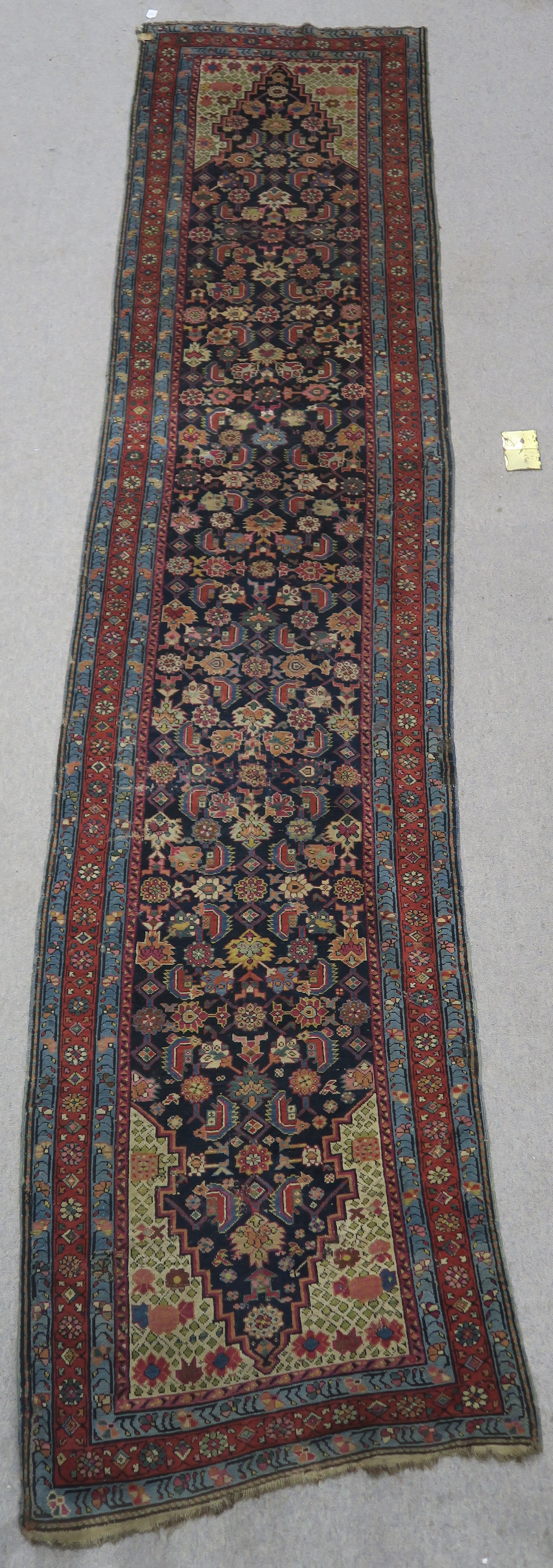 AN INDIGO GROUND PERSIAN RUNNER, with an allover geometric design, cream spandrels within blue and