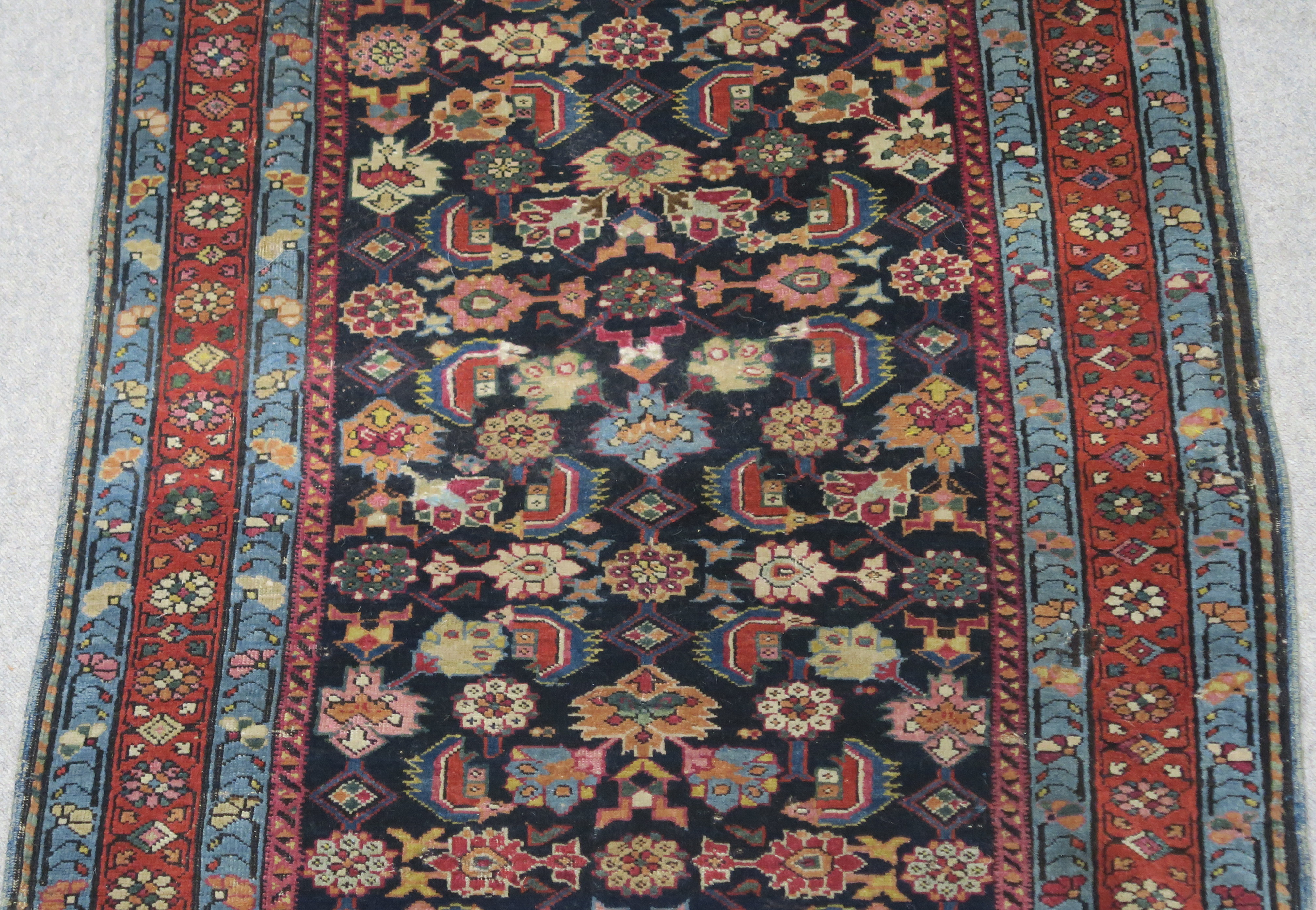 AN INDIGO GROUND PERSIAN RUNNER, with an allover geometric design, cream spandrels within blue and - Image 3 of 12