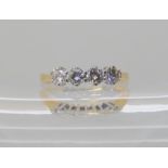 A FOUR STONE DIAMOND RING set with estimated approx 0.68cts of brilliant cut diamonds, finger size