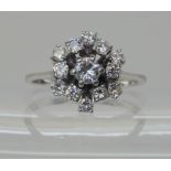 A RETRO DIAMOND FLOWER CLUSTER RING set with estimated approx 0.73cts of brilliant cut diamonds, set