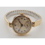 A 9CT GOLD CASED LADIES VINTAGE ROLEX the cream dial stamped Rolex with subsidiary seconds dial, the