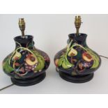 A PAIR OF MOORCROFT QUEENS CHOICE TABLE LAMPS of squat bulbous form, 31cm high Condition Report: