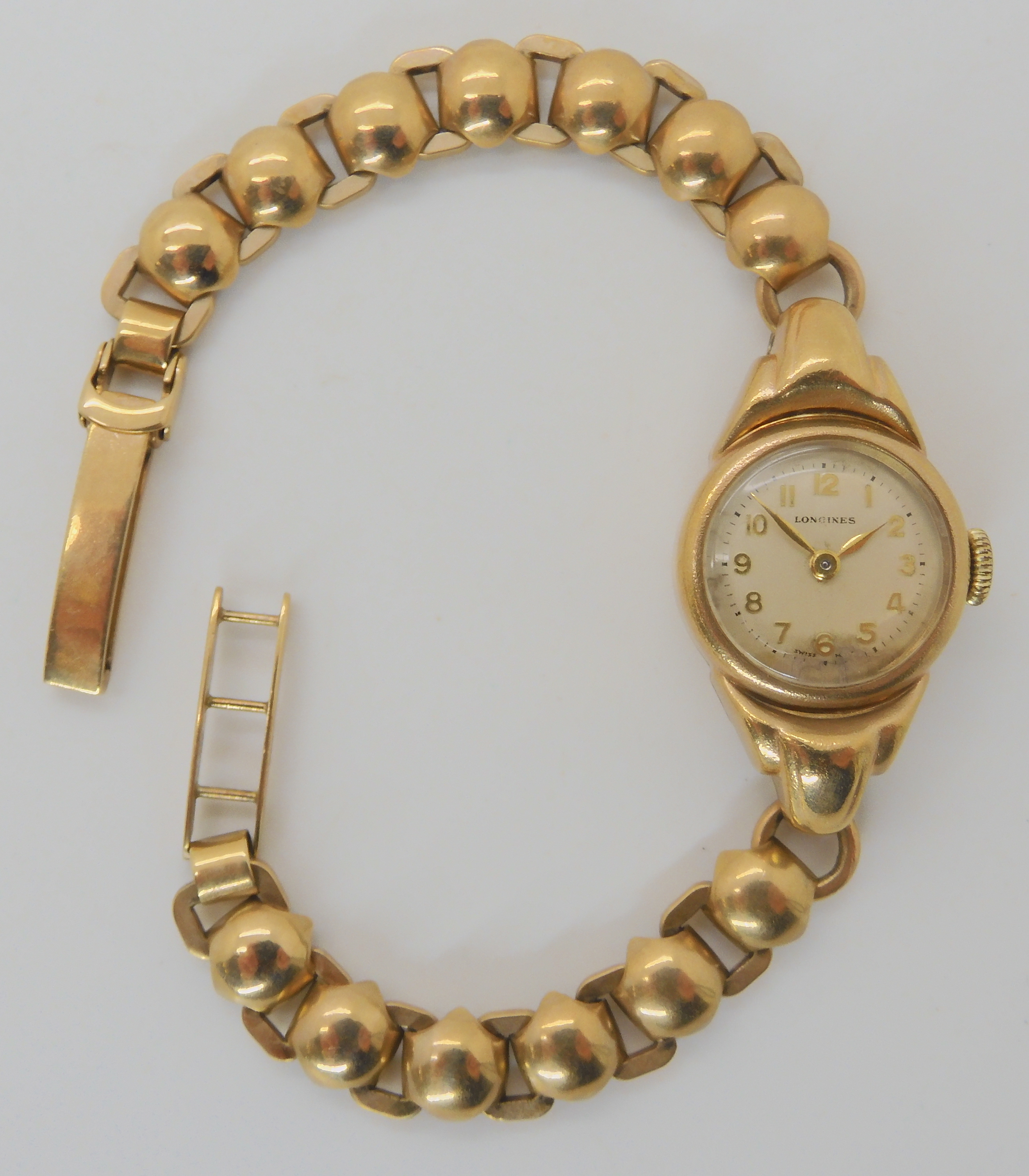 A 9CT GOLD LADIES LONGINES WATCH with decorative strap length 18.5cm, case dimensions 3.3cm x 1.8cm,