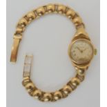 A 9CT GOLD LADIES LONGINES WATCH with decorative strap length 18.5cm, case dimensions 3.3cm x 1.8cm,