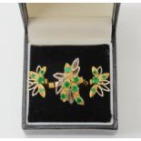 A RETRO EMERALD RING WITH MATCHING EARRINGS An 18ct gold retro ring set with emeralds, size N1/2,
