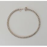 AN 18K WHITE GOLD DIAMOND LINE BRACELET set with estimated approx 2.7cts of brilliant cut