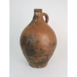 A 17TH CENTURY BELLARMINE STONEWARE JUG with mask incised below the spout, 35cm high Condition