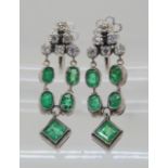 A PAIR OF EMERALD AND DIAMOND DROP EARRINGS mounted in white metal throughout, with screw back