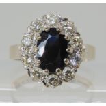 AN 18CT WHITE GOLD SAPPHIRE AND DIAMOND CLUSTER RING set with estimated approx 0.50cts of