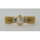 A LADIES 18CT GOLD OMEGA WITH DIAMONDS AND DECORATIVE STRAP the woven mesh strap in puckered to look