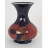 A MOORCROFT POMEGRANATE PATTERN VASE of squat bulbous form with flaring neck, 12.5cm high