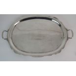 A MEXICAN SILVER TWIN HANDLED SERVING TRAY marked Sterling & 925 of shaped oval form with raised