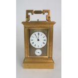 A FRENCH BRASS AND GLASS REPEATER CARRIAGE CLOCK the enamel dial with Roman numerals, with